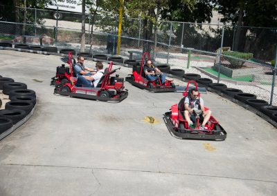 A group of people riding on the back of a kart-3